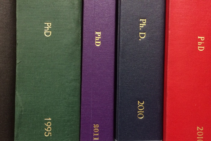 A selection of brightly coloured bound PhD theses